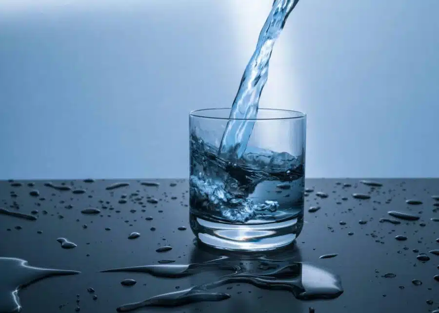 A glass of water being poured