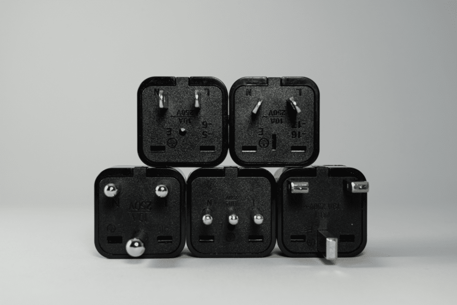five different electrical plug tops