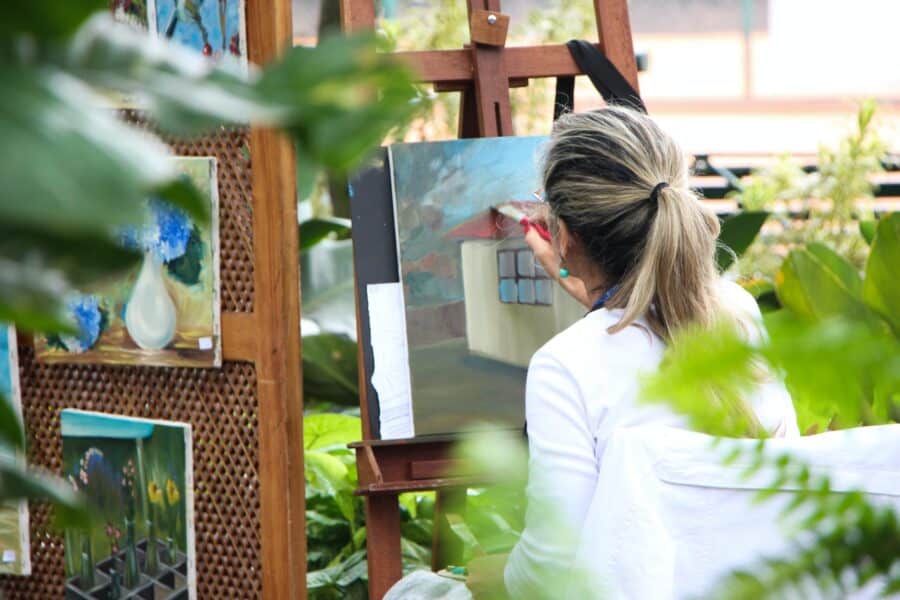 woman painting outdoors while high