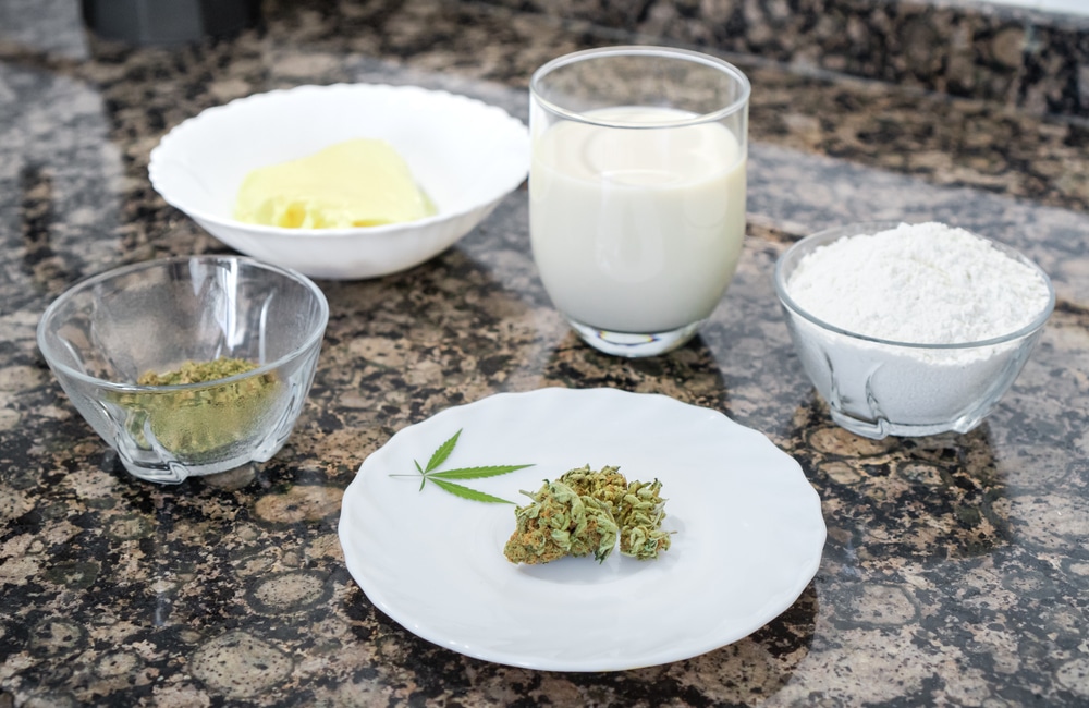 Marijuana bud, milk, flour and other ingredients for cooking with weed