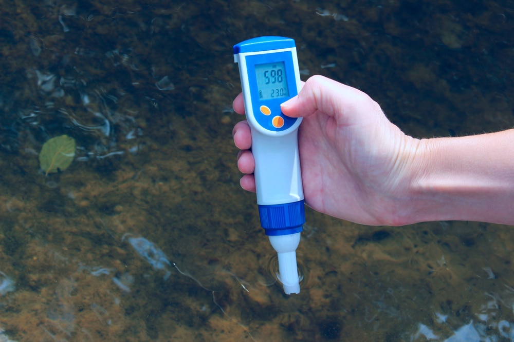 A pH tester being used to check the acidity levels of water